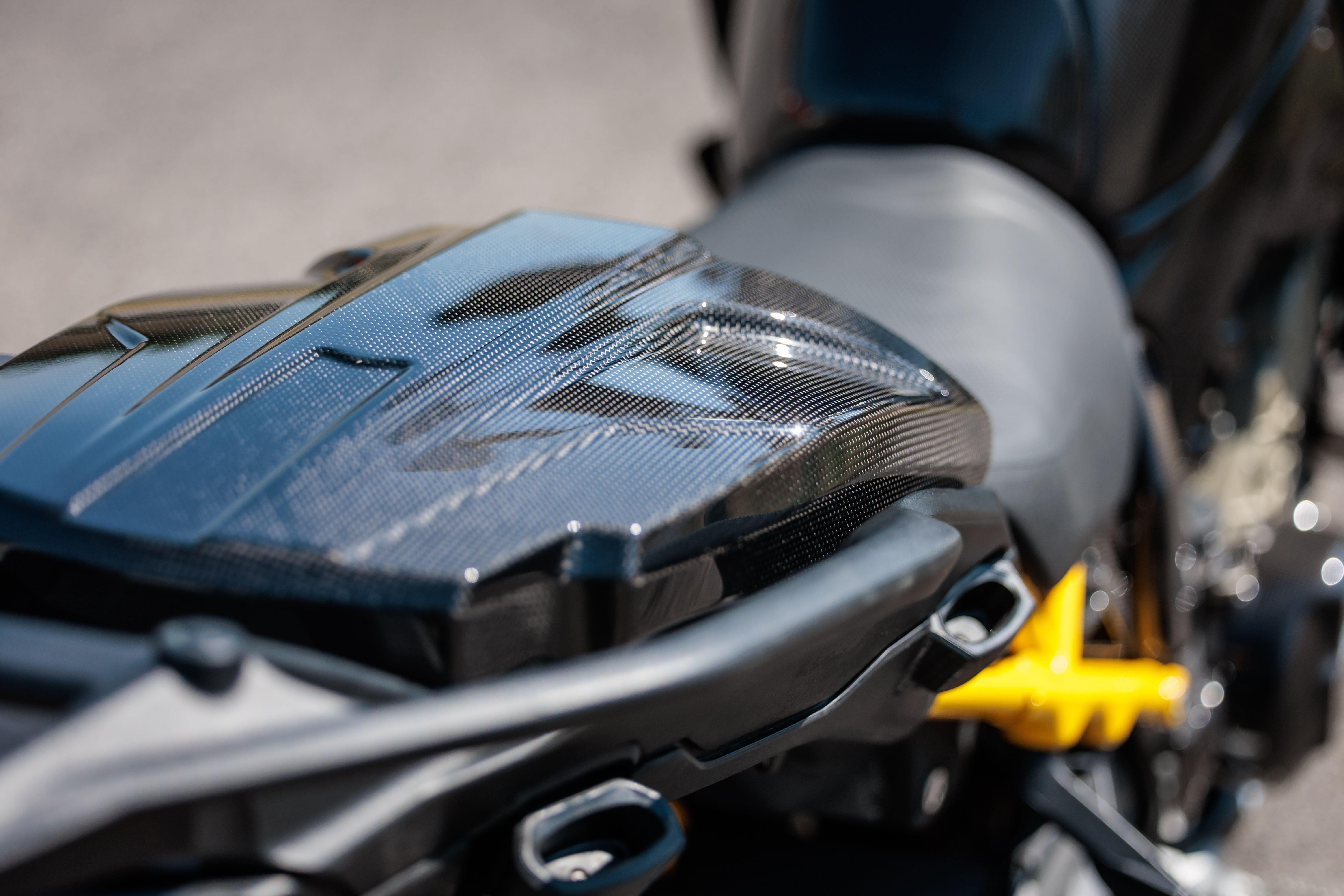 Glossy carbon fairing part on a motorcycle after cleaning